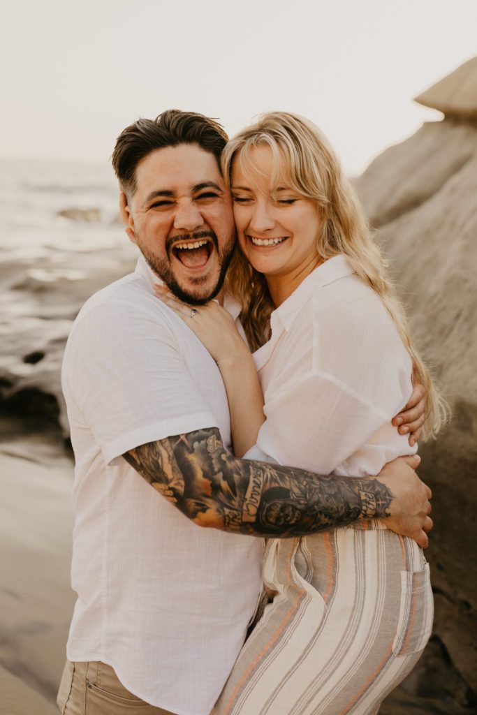 Couple smiling and hugging after their proposal.