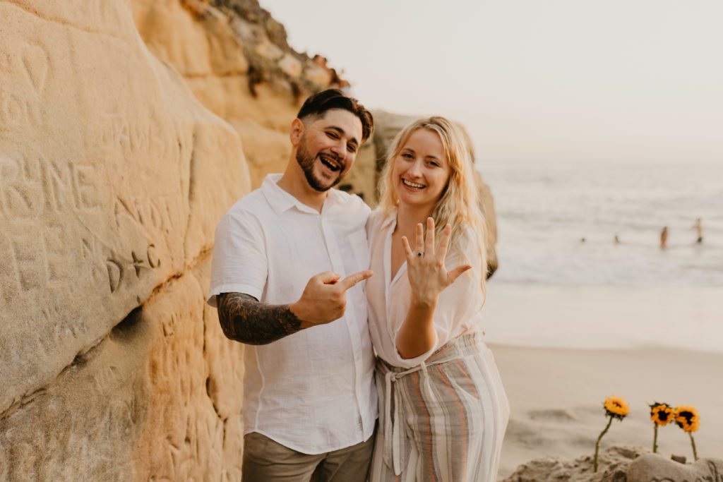 Newly engaged couple showing off their ring.