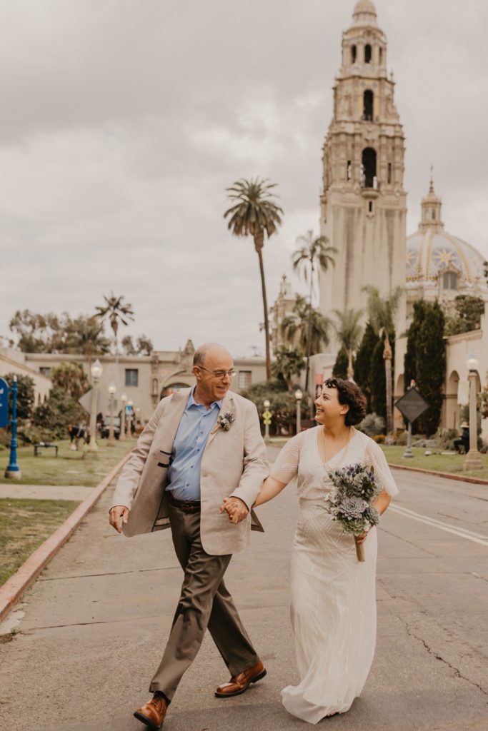 Couple crossing the street at Balboa Park San Diego