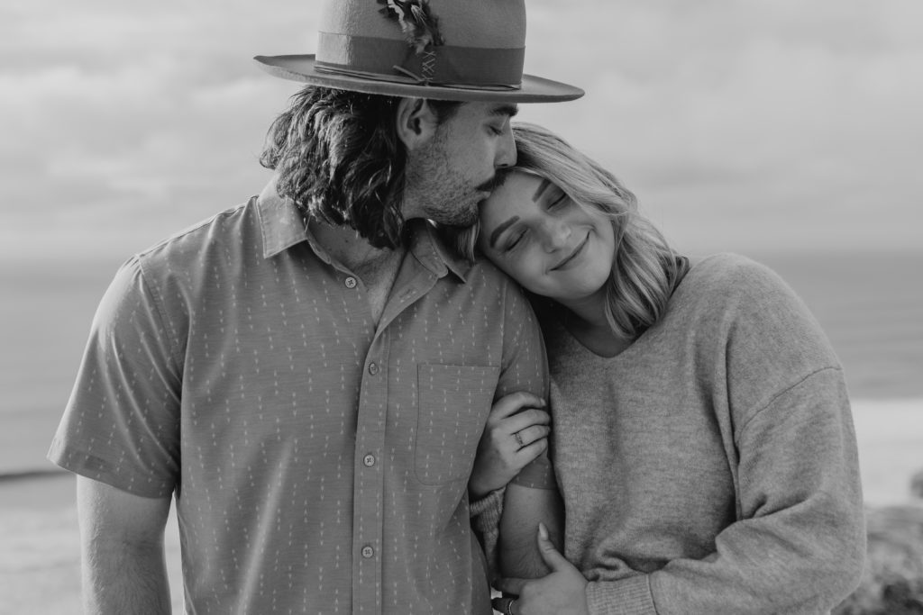 couple resting their heads together for engagement photos