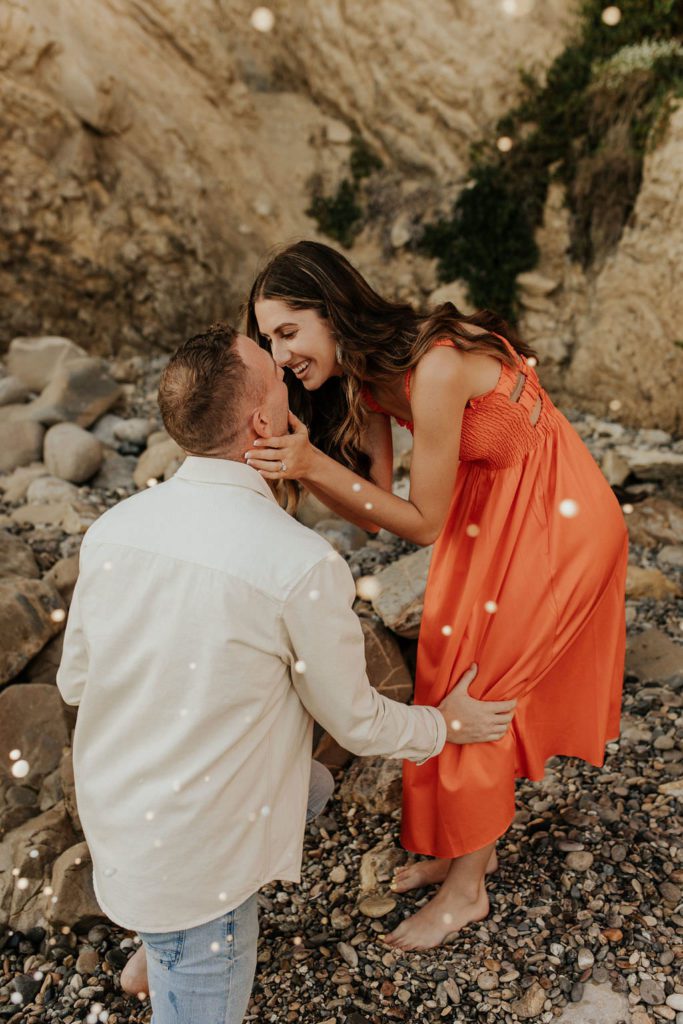 couple leaning in for a kiss after proposal in Newport Beach