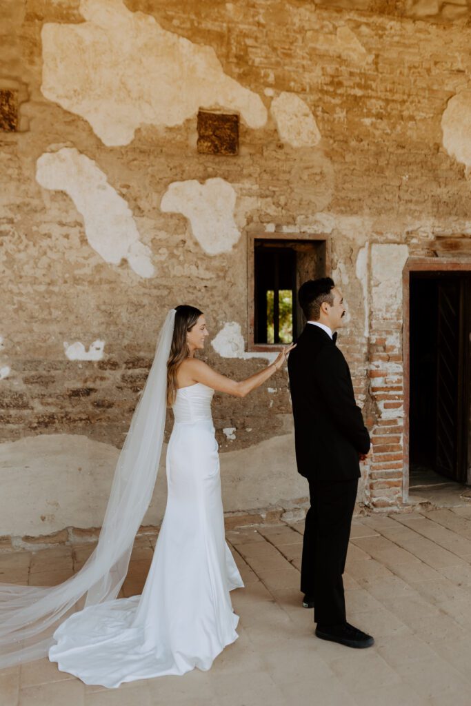 Spanish style wedding photos first look at Mission San Juan Capistrano